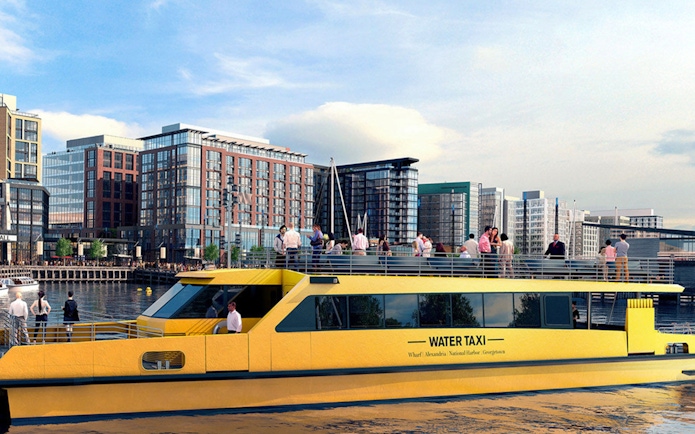 Yellow water taxi on the Potomac River with Washington DC skyline in the background.