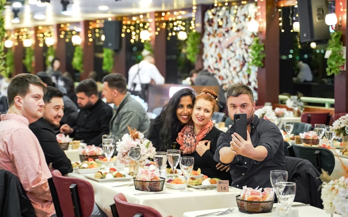 Guests enjoying dinner on a Bosphorus cruise with Turkish show, Istanbul.