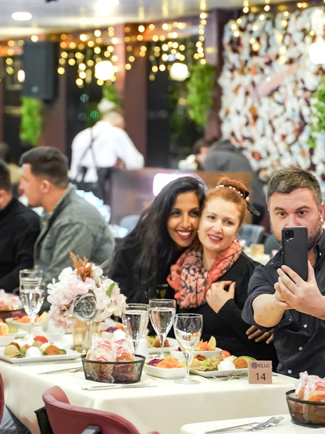 Guests enjoying dinner on a Bosphorus cruise with Turkish show, Istanbul.