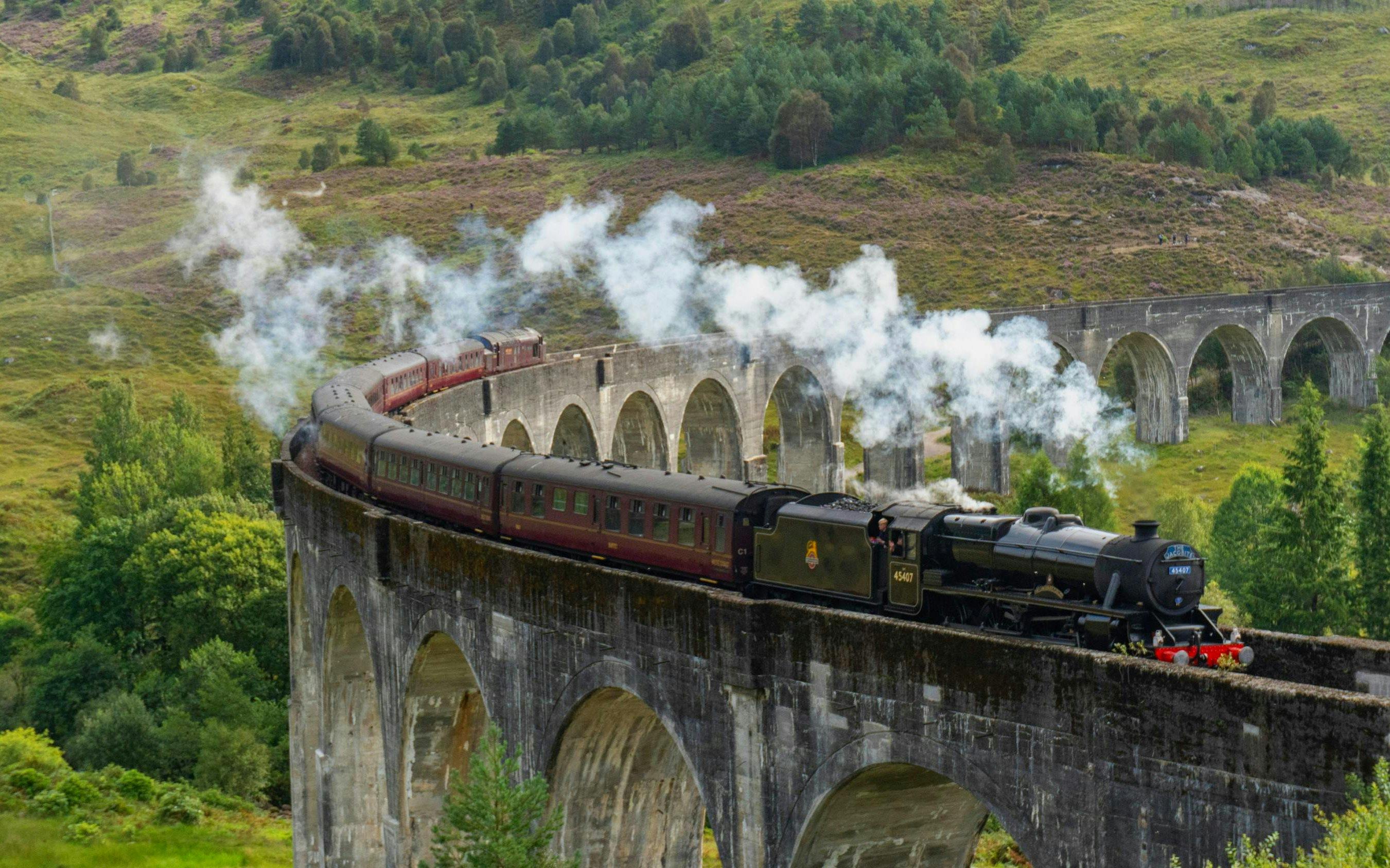 Steam train crossing the Glenfinnan Viaduct in Scotland.