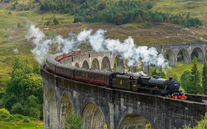 Steam train crossing the Glenfinnan Viaduct in Scotland.