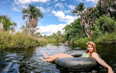 Tubing in Cardosa river surrounded by lush greenery, Barreirinhas, Sao Paulo.