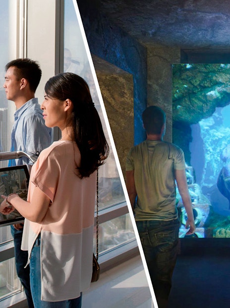 Visitors exploring The Lost World Aquarium with a large prehistoric fish display.
