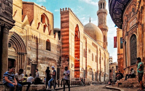 Old Cairo street with Islamic architecture and people near Saladin Citadel.