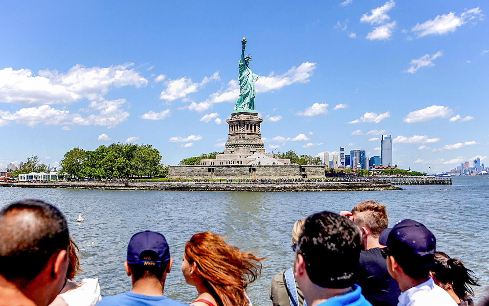 Tourist viewing Statue of Liberty from New York City sightseeing cruise