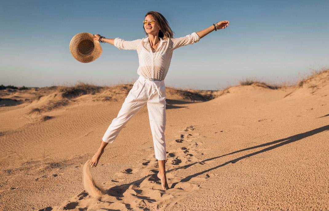A woman taking a stroll in the desert, Dubai.