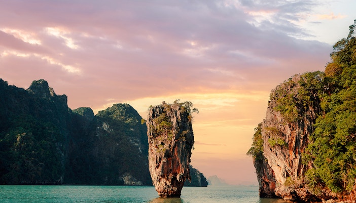 James Bond Island at sunset with limestone cliffs in Phang Nga Bay, Thailand.