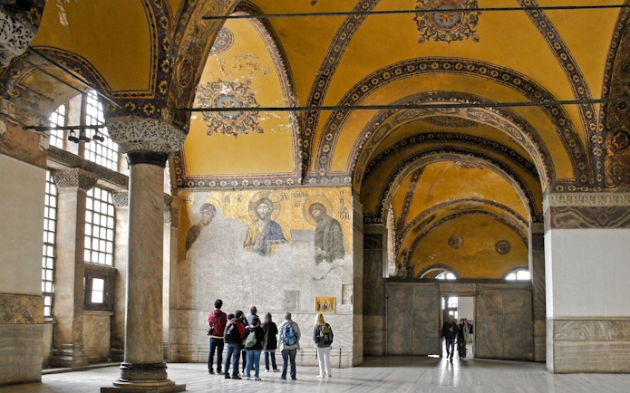Visitors viewing Deesis mosaic in Hagia Sophia, Istanbul, Turkey.