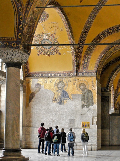 Visitors viewing Deesis mosaic in Hagia Sophia, Istanbul, Turkey.