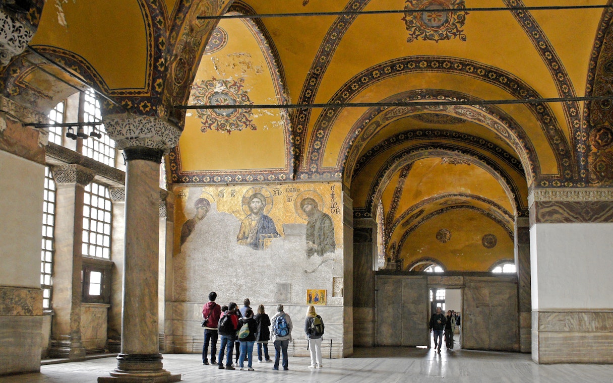 Visitors viewing Deesis mosaic in Hagia Sophia, Istanbul, Turkey.