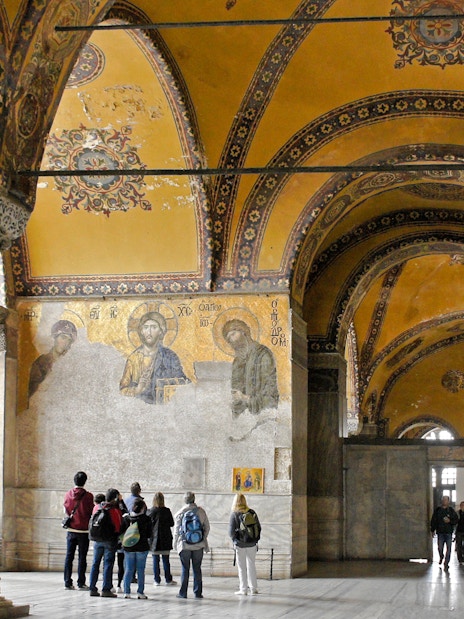 Visitors viewing Deesis mosaic in Hagia Sophia, Istanbul, Turkey.