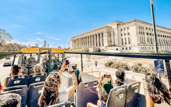 Open-top bus tour passing by the University of Buenos Aires Law School.