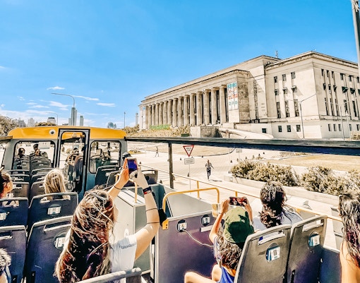 Open-top bus tour passing by the University of Buenos Aires Law School.