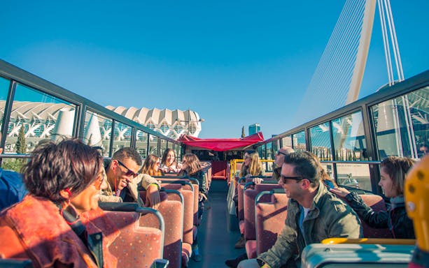 Passengers enjoying the view from the upper deck of the Valencia Hop on Hop Off Bus.