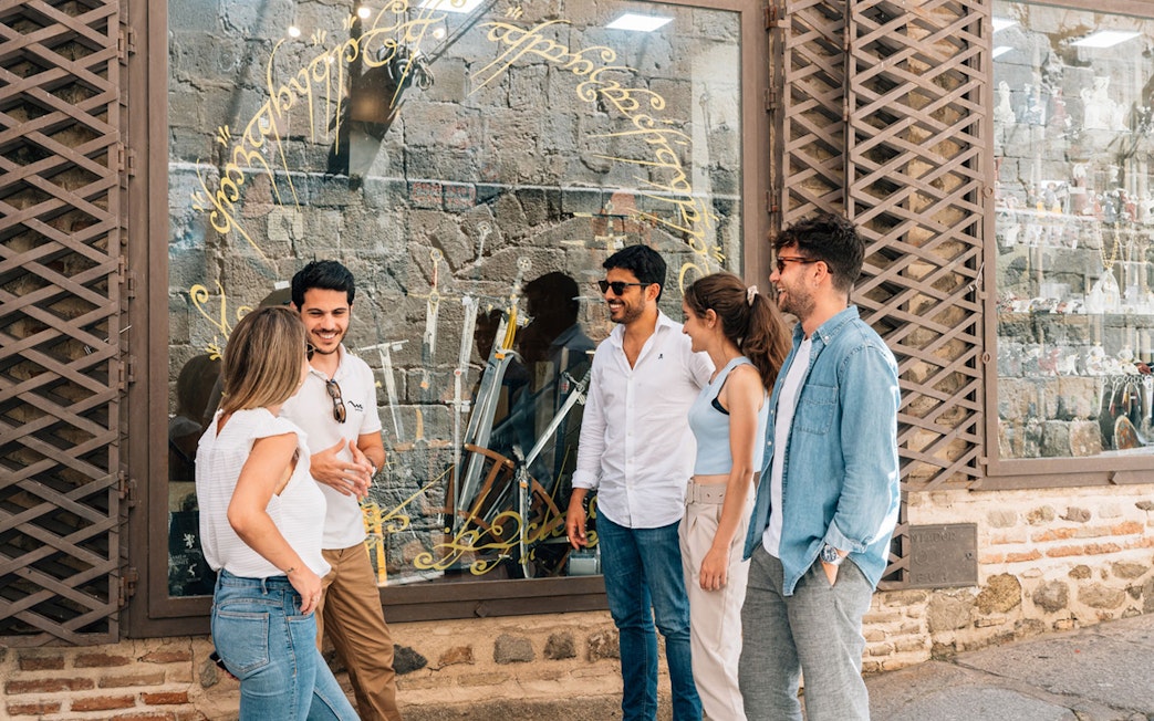 Tourist group with guide outside a sword shop in Toledo.