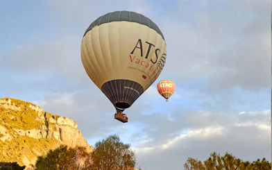 Hot air balloons floating over Ihlara Canyon at sunrise, Cappadocia.