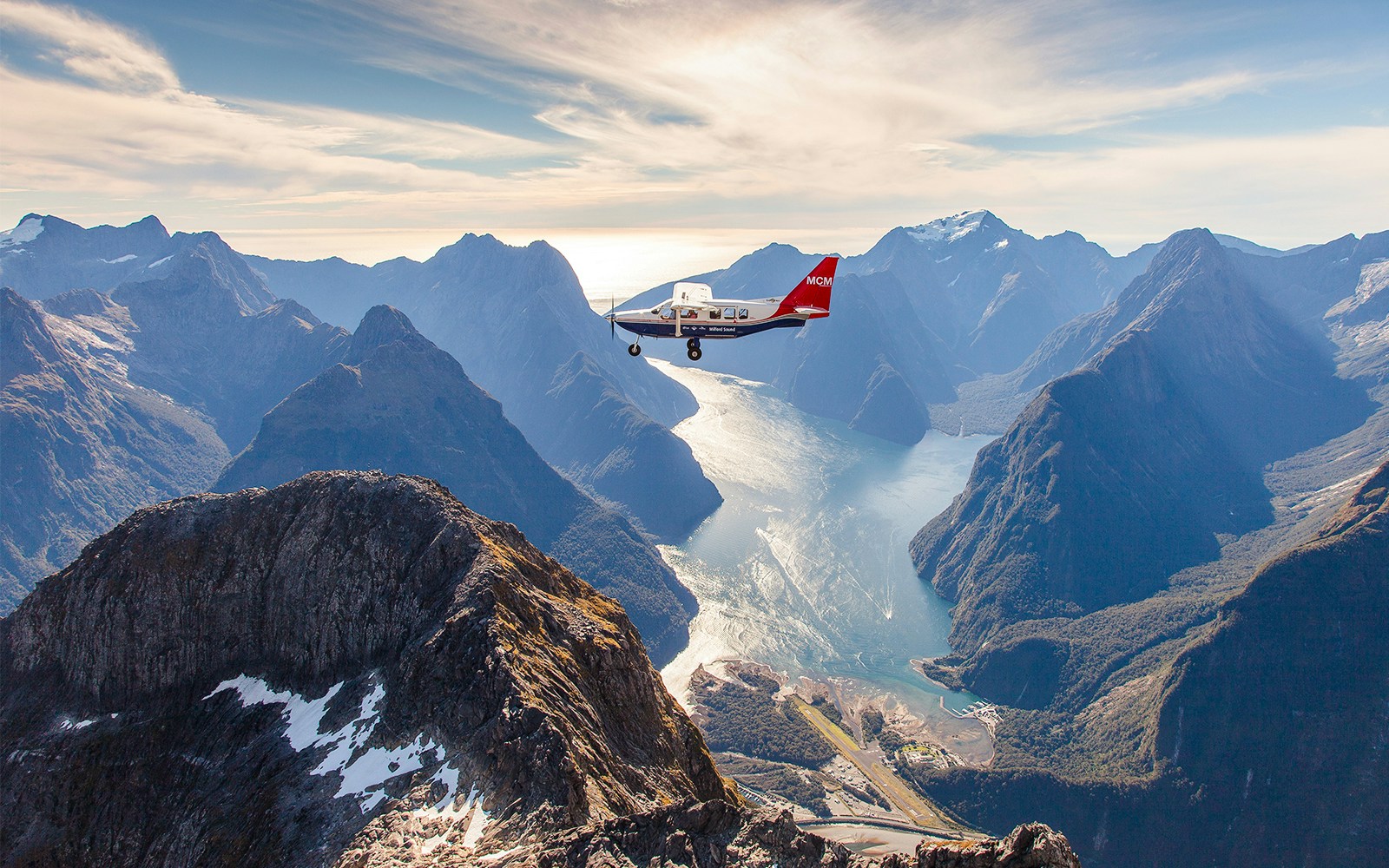 Milford Sound aerial view with cruise ship, Queenstown scenic flyover experience.