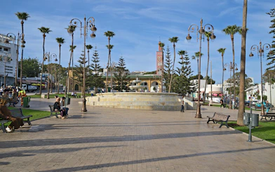 Grand Socco market square in Tangier with fountain and palm trees.