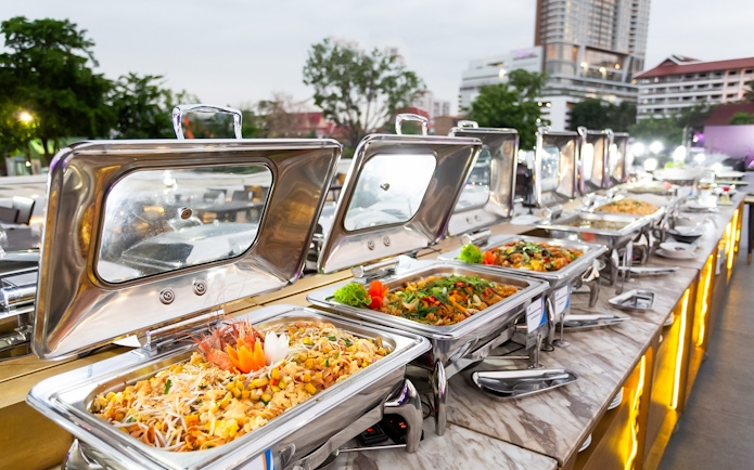 Buffet spread with various dishes on a cruise ship deck.