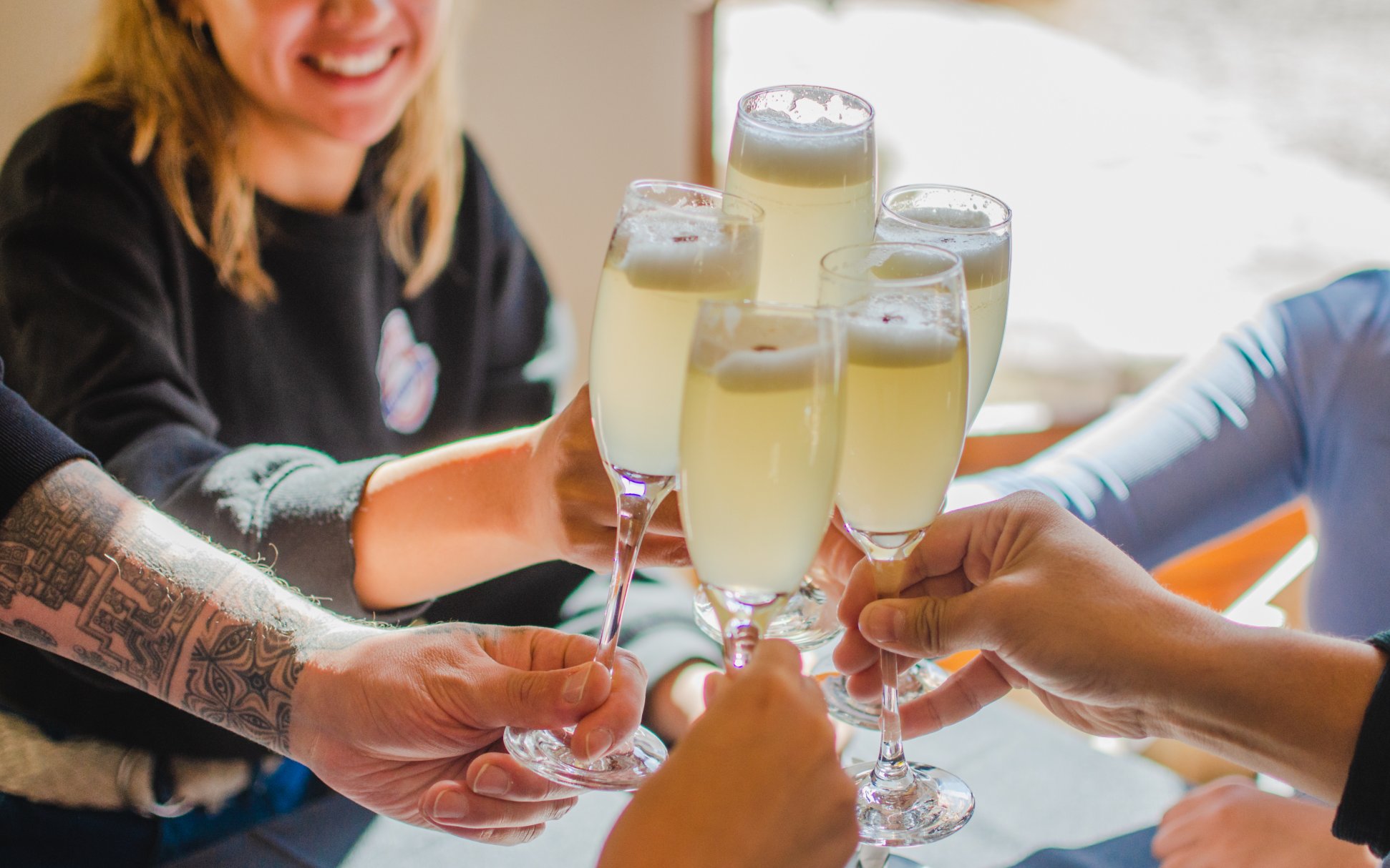 Tourists toasting with drinks at El Morado Lodge and Spa, Chile.