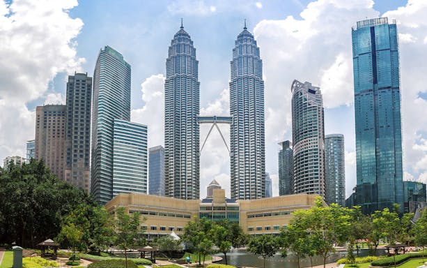 Petronas Twin Towers in Kuala Lumpur cityscape.