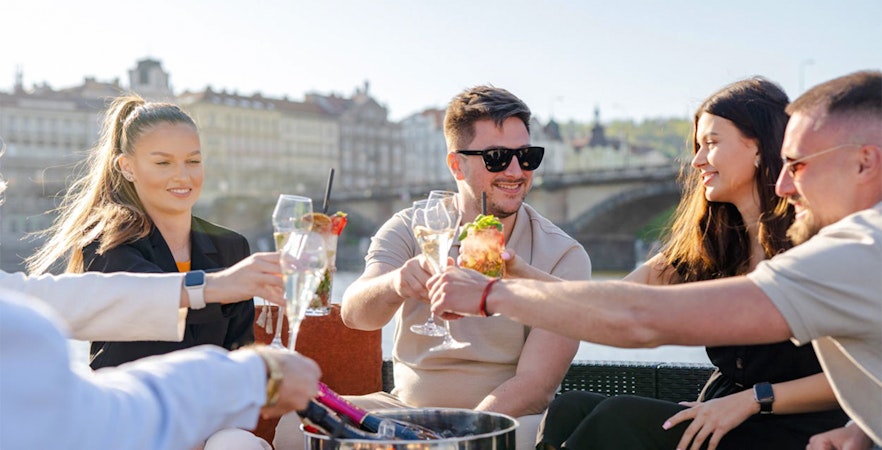 Tourists enjoying beer on beer boat in Prague