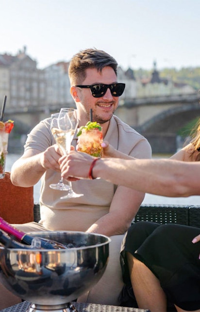 Group of friends enjoying Prosecco on a yacht in Prague.