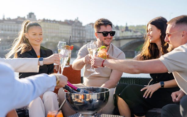 Group of friends enjoying Prosecco on a yacht in Prague.
