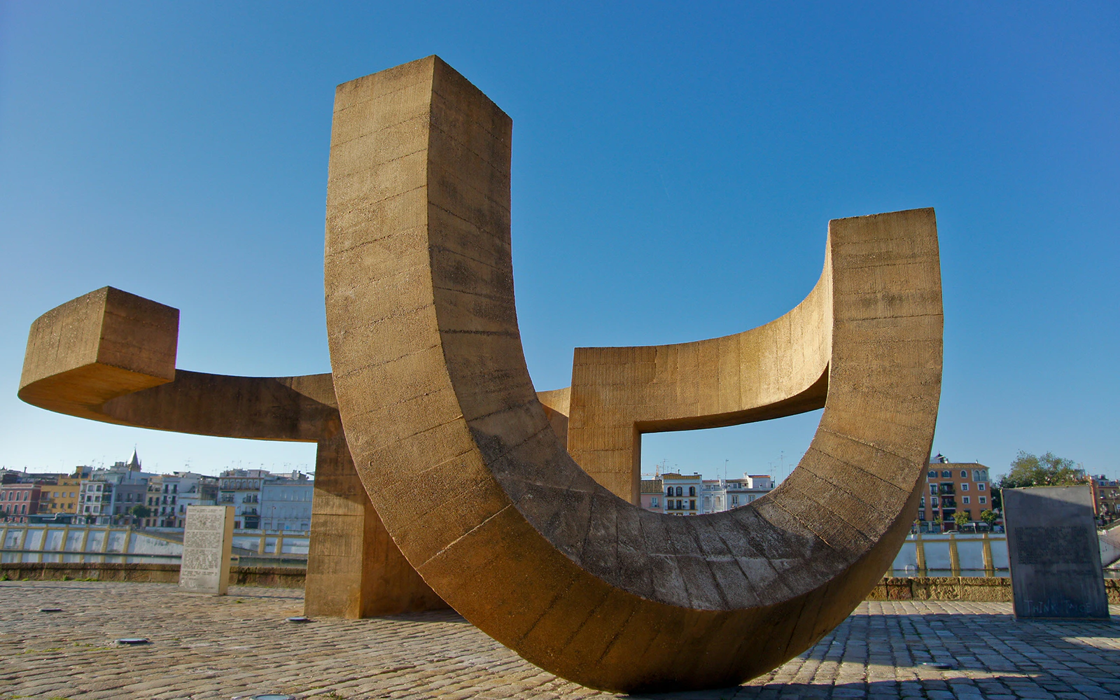 Modern sculpture at MACBA in Barcelona with cityscape in the background.