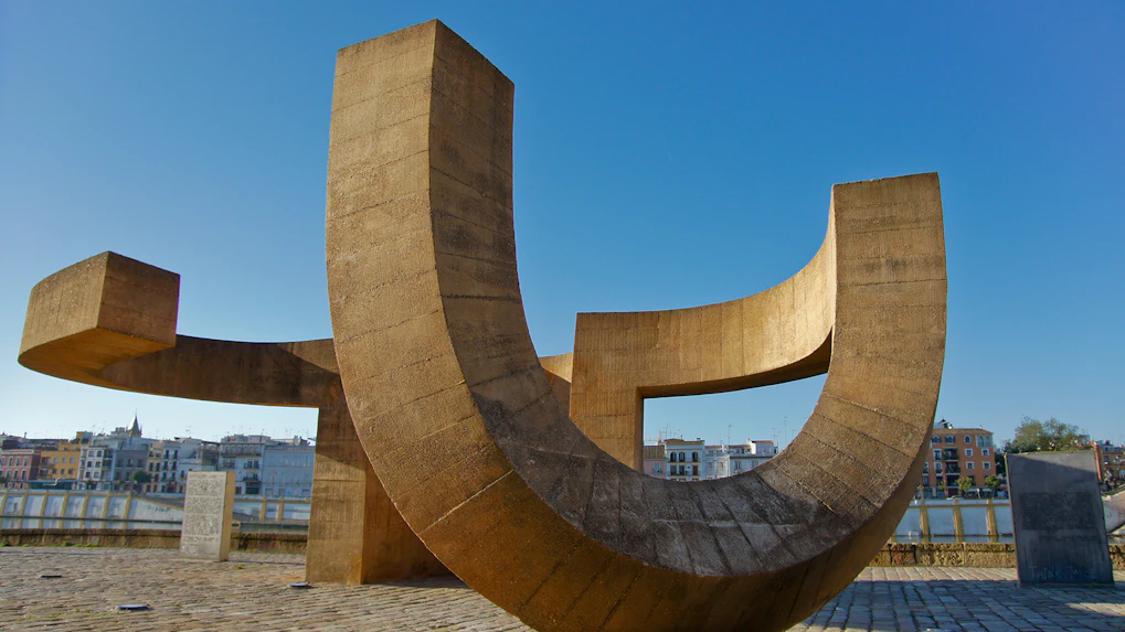 Modern sculpture at MACBA in Barcelona with cityscape in the background.