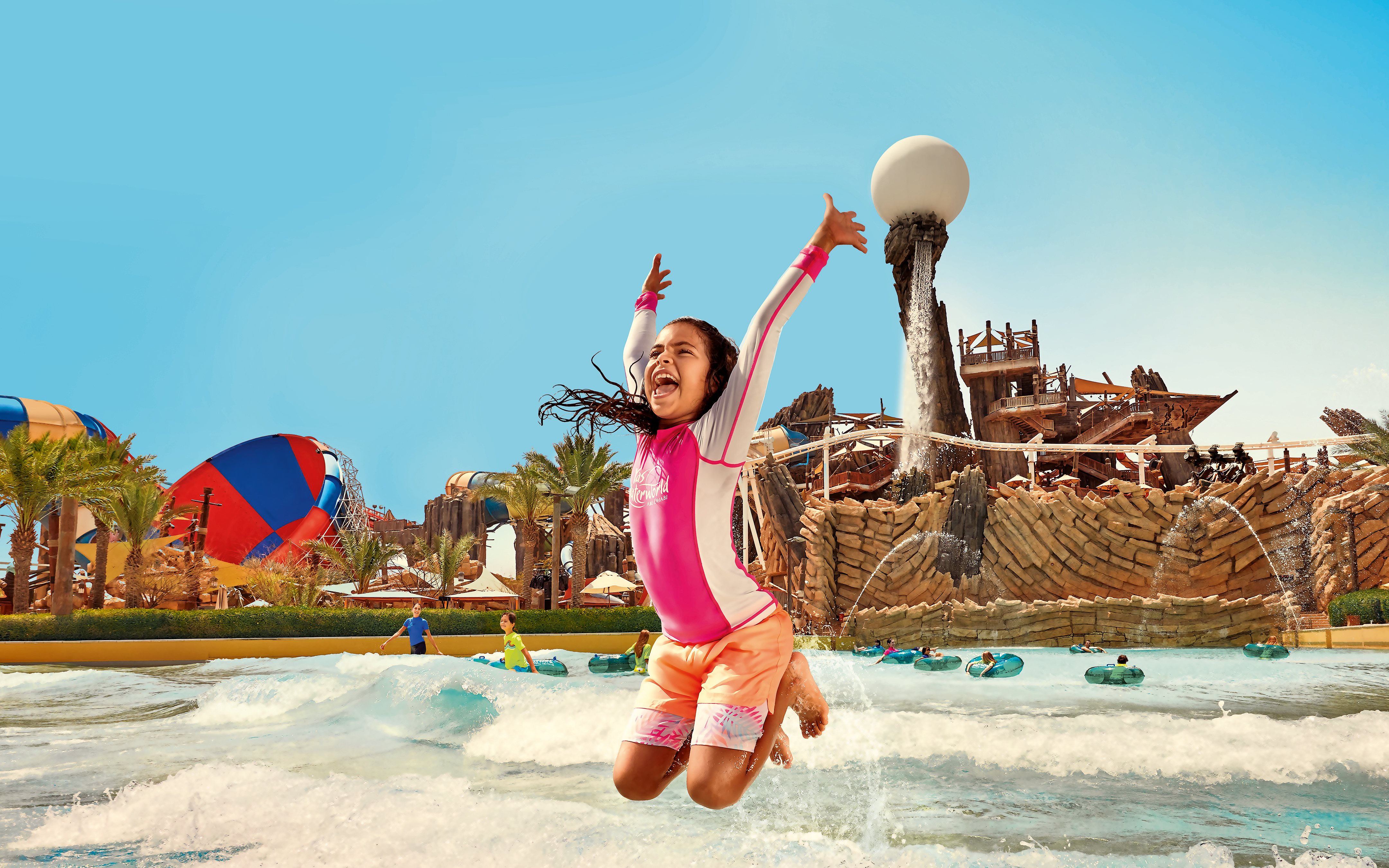 Kid jumping in Amwaj Wave Pool at YAS Waterworld, Abu Dhabi.