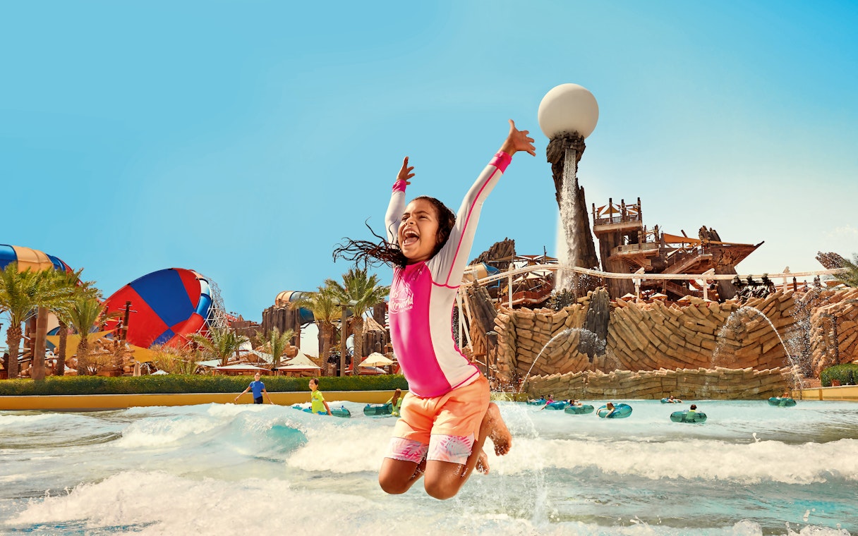 Kid jumping in Amwaj Wave Pool at YAS Waterworld, Abu Dhabi.