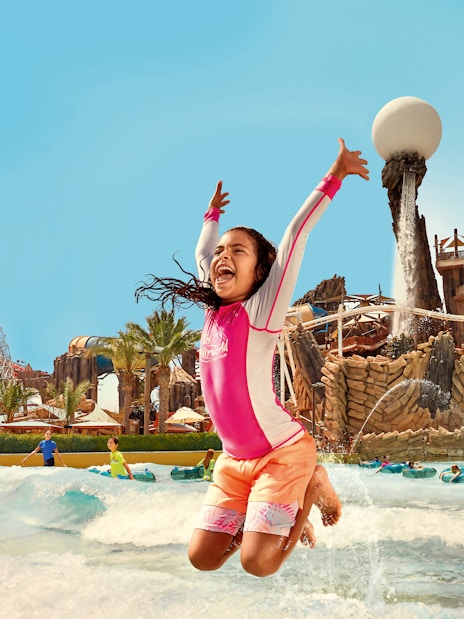 Kid jumping in Amwaj Wave Pool at YAS Waterworld, Abu Dhabi.