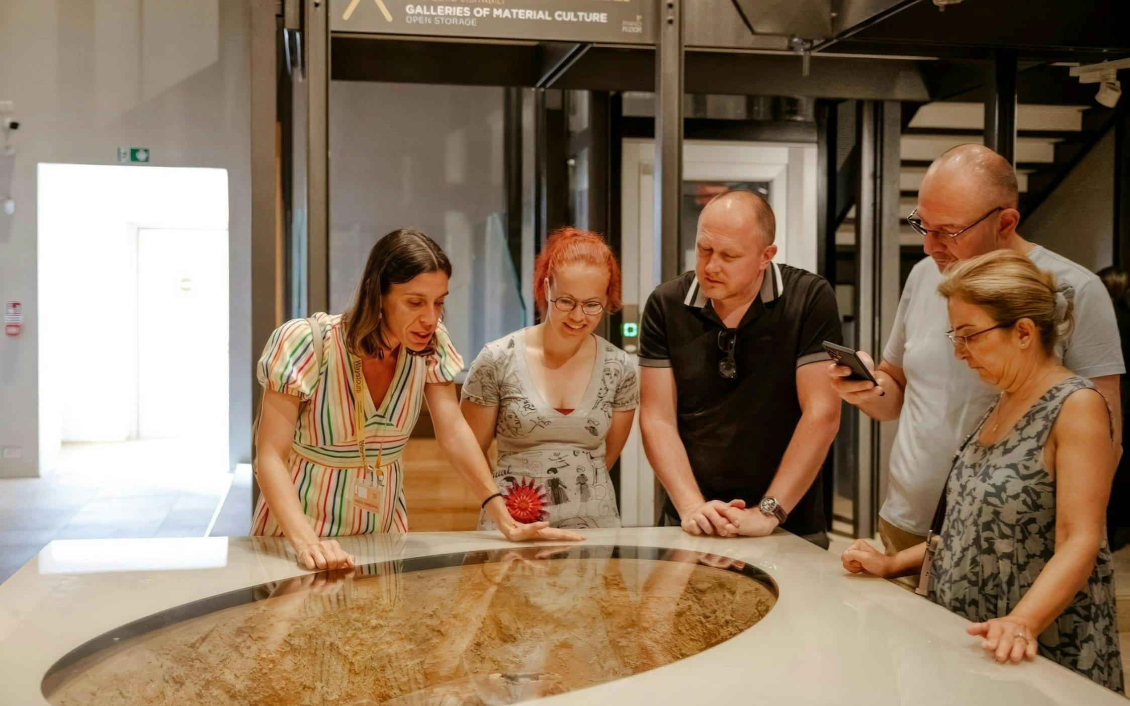 Visitors examining an exhibit at the Egyptian Museum in Turin.