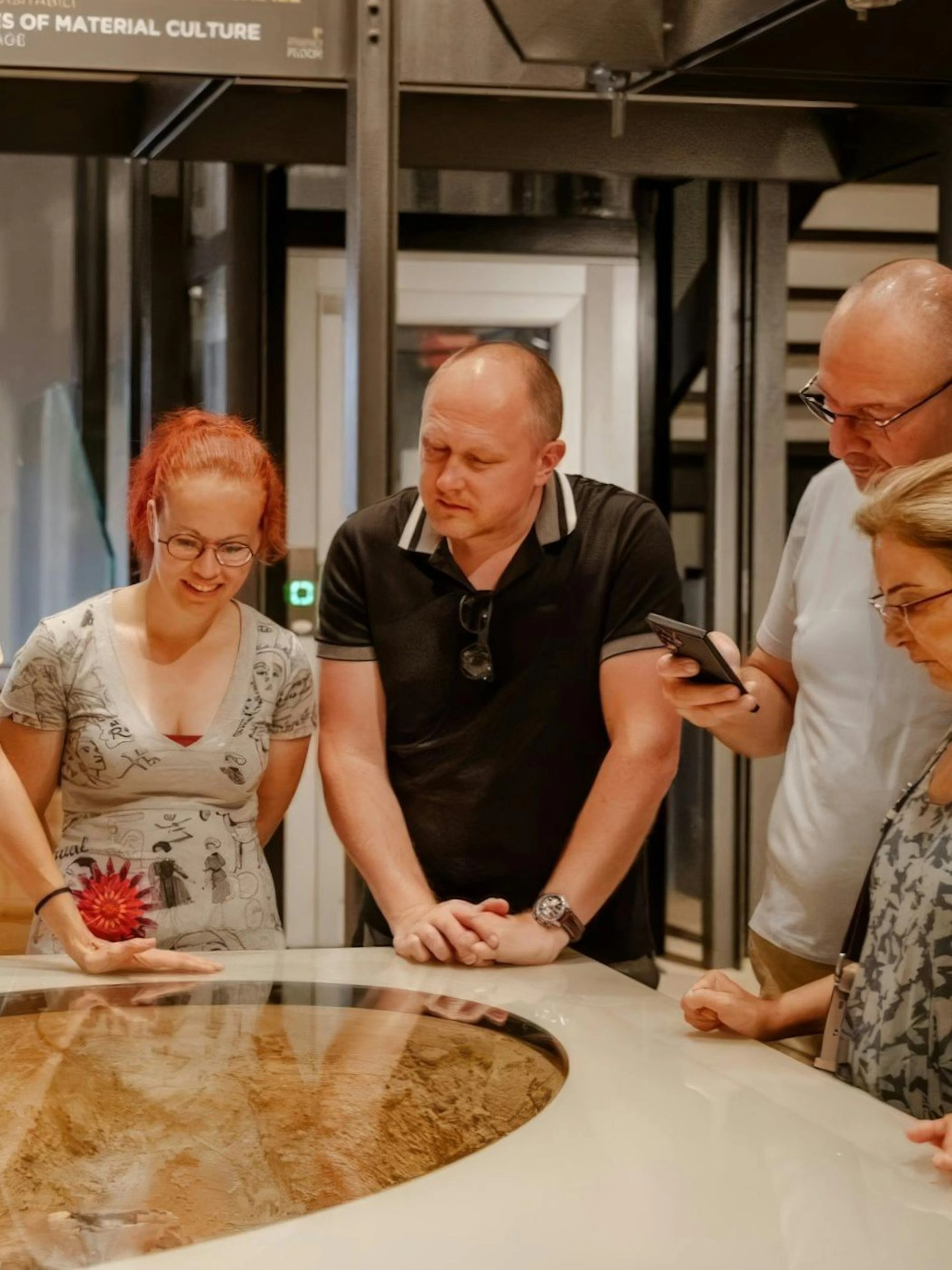 Visitors examining an exhibit at the Egyptian Museum in Turin.