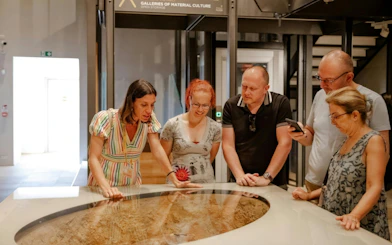 Visitors examining an exhibit at the Egyptian Museum in Turin.