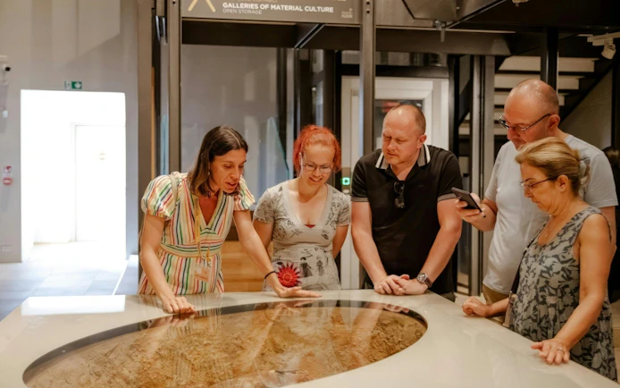 Visitors examining an exhibit at the Egyptian Museum in Turin.
