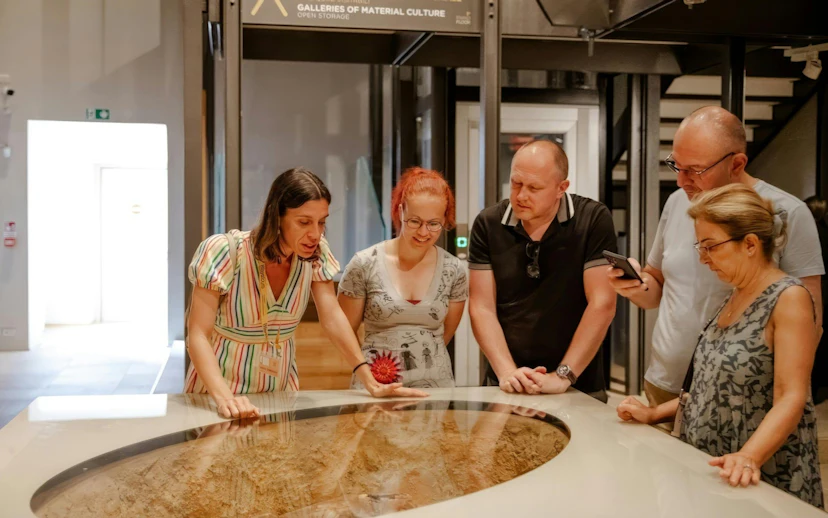 Visitors examining an exhibit at the Egyptian Museum in Turin.