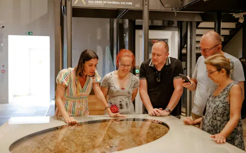 Visitors examining an exhibit at the Egyptian Museum in Turin.
