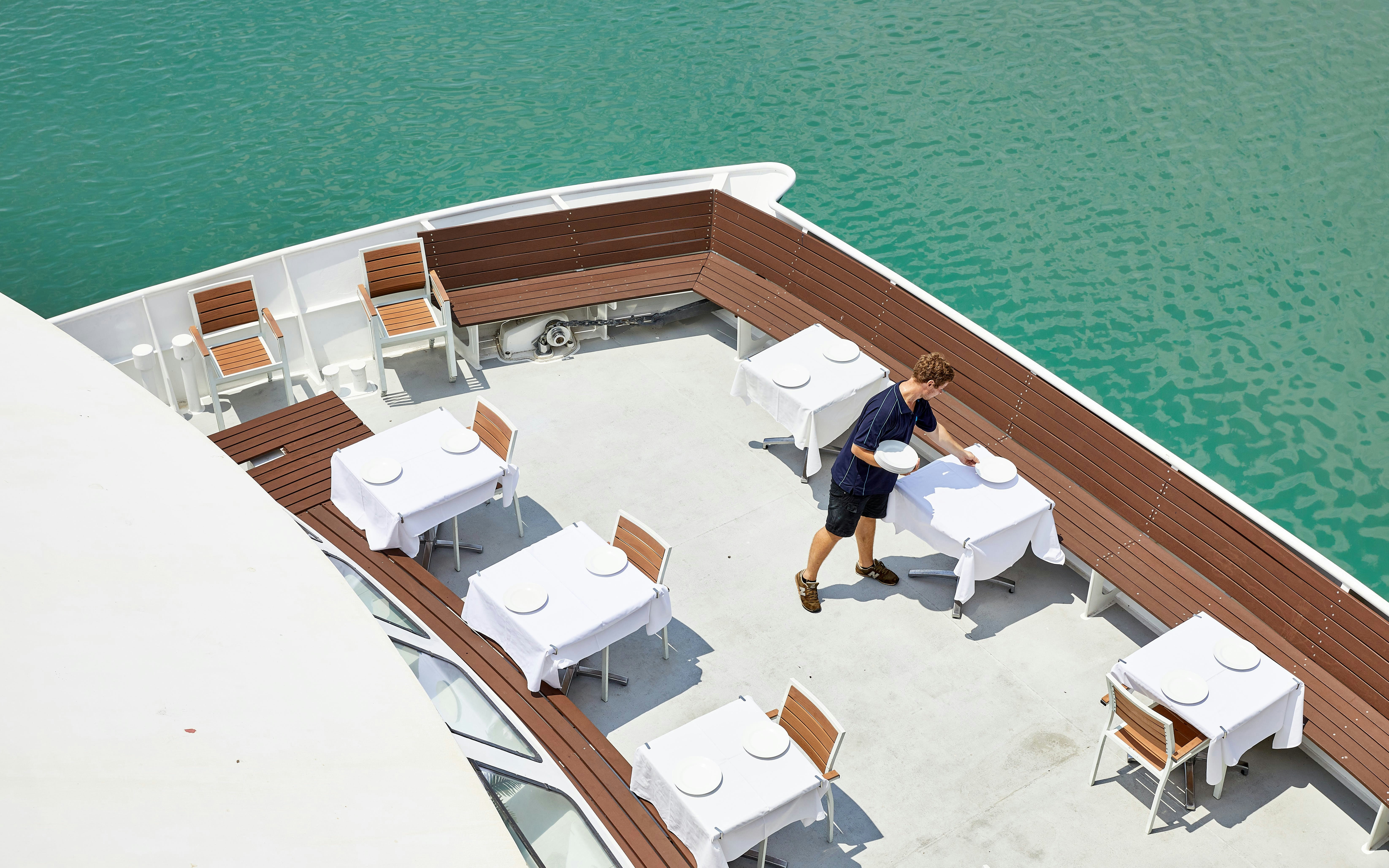 Lunch tables set on a boat deck for Darwin Harbour cruise.