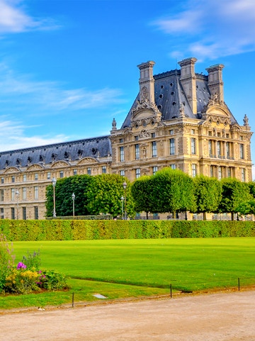 Palace of Versailles gardens with historic building in Paris, France.