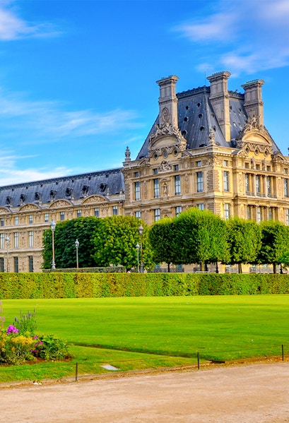 Palace of Versailles gardens with historic building in Paris, France.