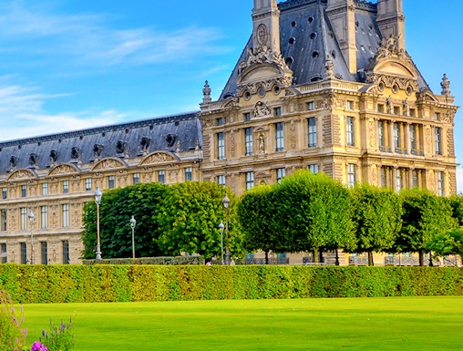 Palace of Versailles gardens with historic building in Paris, France.