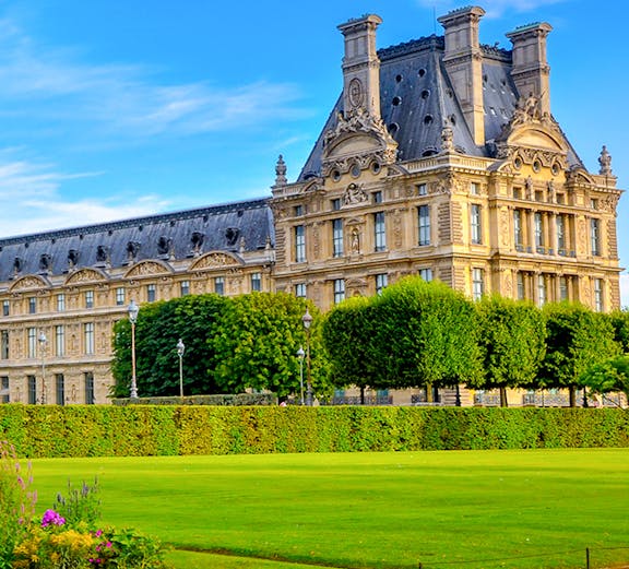 Palace of Versailles gardens with historic building in Paris, France.