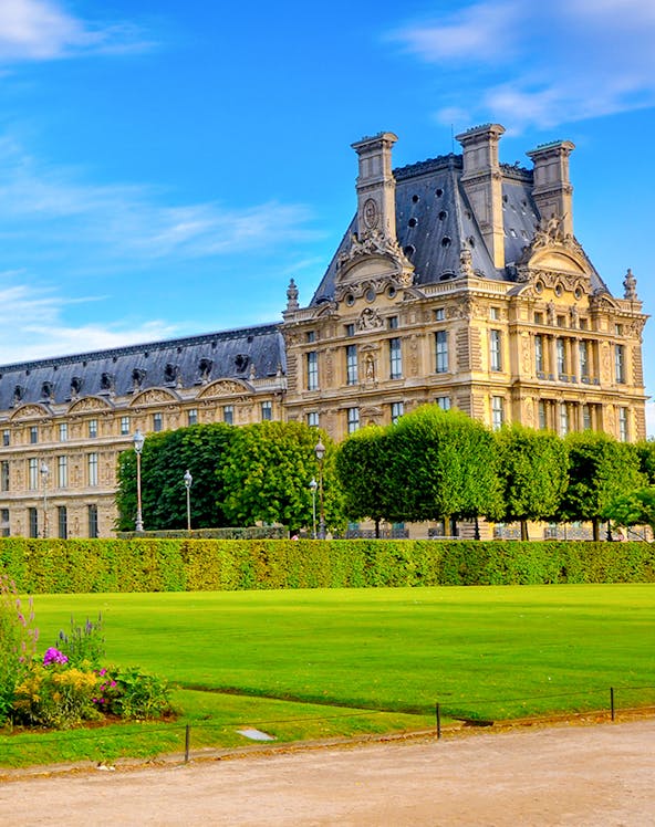 Palace of Versailles gardens with historic building in Paris, France.