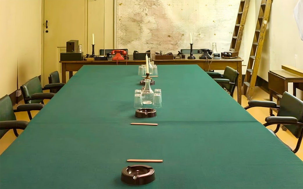 Meeting room in Churchill War Rooms with map and vintage telephones.