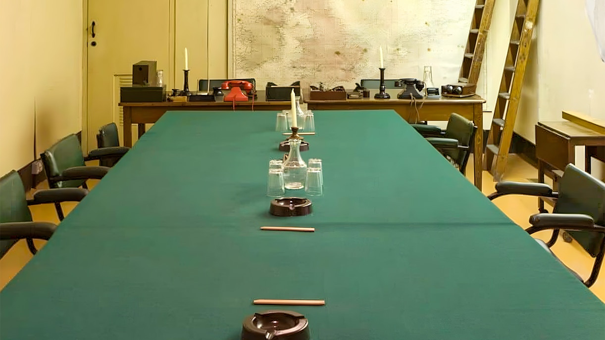 Meeting room in Churchill War Rooms with map and vintage telephones.