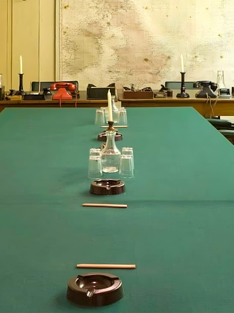 Meeting room in Churchill War Rooms with map and vintage telephones.