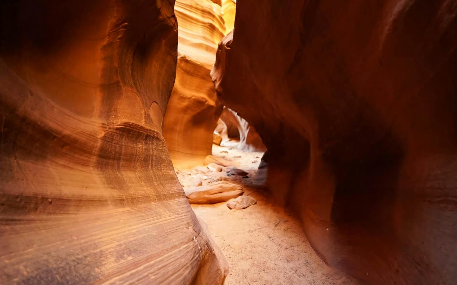 Upper Antelope Canyon sandstone passage with sunlight filtering through.