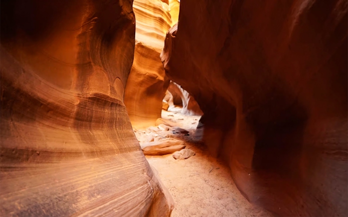 Upper Antelope Canyon sandstone passage with sunlight filtering through.